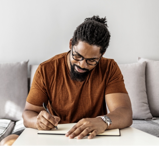 Man writing in a journal.