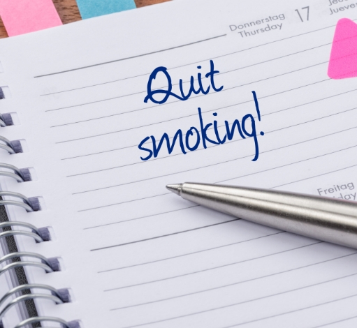 Notebook with the words Quit Smoking written.
