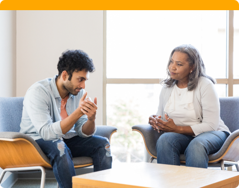 Two people talking in a doctor's office.